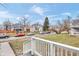 View from a porch of a residential street with parked cars and various houses at 2709 Station St, Indianapolis, IN 46218