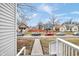 Front view of a house with a white porch and steps leading to a street with parked cars at 2709 Station St, Indianapolis, IN 46218