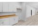 Spacious kitchen with white cabinetry, butcher block countertops, and ample storage at 2709 Station St, Indianapolis, IN 46218