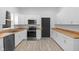 Bright kitchen boasts white shaker cabinets, wood countertops, and stainless steel appliances at 2709 Station St, Indianapolis, IN 46218