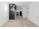 Living room with dark accent wall, modern light fixture and view of the kitchen at 2709 Station St, Indianapolis, IN 46218