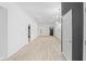 Bright living room with dark accent wall, modern light fixture, and wood-look flooring at 2709 Station St, Indianapolis, IN 46218
