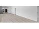 Spacious living area with white walls and light wood-look floors, showcasing its size and layout at 2709 Station St, Indianapolis, IN 46218
