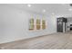 Living room with multiple windows providing natural light, and light wood-look flooring at 2709 Station St, Indianapolis, IN 46218