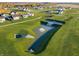 Aerial view of the community with homes and a pond at 310 N Bur Oak Dr, Mooresville, IN 46158