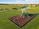 Community playground with swings and slides, next to a pond at 310 N Bur Oak Dr, Mooresville, IN 46158