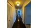 Long hallway with dark hardwood floors and light walls at 4000 N Meridian St # 2H, Indianapolis, IN 46208