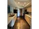 Galley kitchen with light wood cabinets and dark hardwood floors at 4000 N Meridian St # 2H, Indianapolis, IN 46208