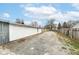Large backyard with gravel area and wooden fence at 4925 W Raymond St, Indianapolis, IN 46241