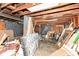 Partially finished basement with exposed beams and storage at 4925 W Raymond St, Indianapolis, IN 46241