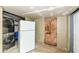 Unfinished basement with washer, dryer, and refrigerator at 4925 W Raymond St, Indianapolis, IN 46241