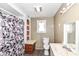 Bathroom with shower, toilet, sink, and built-in shelving at 4925 W Raymond St, Indianapolis, IN 46241