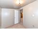 Small bedroom with carpeted floor and door to another room at 4925 W Raymond St, Indianapolis, IN 46241