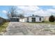 White ranch house with gray doors and detached garage at 4925 W Raymond St, Indianapolis, IN 46241