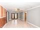 Living area with laminate floors and access to the outside at 4925 W Raymond St, Indianapolis, IN 46241