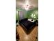 Green bedroom with king-size bed and ceiling fan at 5126 Seerley Creek Rd, Indianapolis, IN 46241