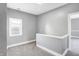 Hallway with gray walls, white trim, carpeted flooring, and a window at 593 Walnut St, Noblesville, IN 46060