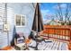 View of a blue house exterior with a wooden deck, dusted with snow at 593 Walnut St, Noblesville, IN 46060