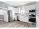 Modern kitchen with stainless steel appliances, white cabinets, and granite countertops at 593 Walnut St, Noblesville, IN 46060