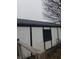 Side view of detached garage with black trim and window, and a gray roof at 603 W Broadway St, Alexandria, IN 46001