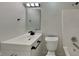 Clean and bright bathroom with white fixtures, a shower/tub combo, and marble-look tile flooring at 6110 Prairie Stream Way, Columbus, IN 47203