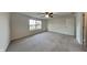 Spacious bedroom with plush carpeting and large window at 6110 Prairie Stream Way, Columbus, IN 47203