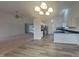 Open concept kitchen and dining area with hardwood floors at 6110 Prairie Stream Way, Columbus, IN 47203