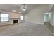 Spacious living room with vaulted ceiling, cozy fireplace, and plush carpet at 6110 Prairie Stream Way, Columbus, IN 47203