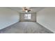 Large main bedroom with carpeted flooring, ceiling fan, and ample natural light at 6110 Prairie Stream Way, Columbus, IN 47203