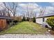 Large backyard with grassy area and brick patio at 6348 Kingsley Dr, Indianapolis, IN 46220