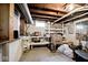 Unfinished basement area with workbench and storage shelves at 6348 Kingsley Dr, Indianapolis, IN 46220