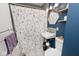 Updated bathroom with floral shower curtain and hexagon mirror at 6348 Kingsley Dr, Indianapolis, IN 46220