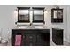 Double vanity bathroom with granite countertop and dark cabinets at 6348 Kingsley Dr, Indianapolis, IN 46220