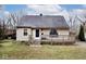 Beige house with gray roof, wooden deck, and steps at 6348 Kingsley Dr, Indianapolis, IN 46220