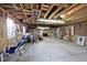Unfinished garage with high ceilings and ample storage at 6348 Kingsley Dr, Indianapolis, IN 46220