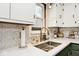 Modern kitchen sink and countertop with herringbone backsplash at 6348 Kingsley Dr, Indianapolis, IN 46220