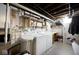 Basement laundry room with washer, dryer, and utility shelving at 6348 Kingsley Dr, Indianapolis, IN 46220