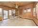 Bright sunroom features wood walls, ceiling fan, and access to backyard at 6348 Kingsley Dr, Indianapolis, IN 46220