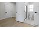 View of a bathroom through an open doorway, with wood-look flooring and a glass shower at 6422 Norwich Dr, Brownsburg, IN 46112