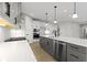 Modern kitchen with white quartz counters, dark gray island, and stainless steel appliances at 6422 Norwich Dr, Brownsburg, IN 46112