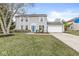 Two-story house with blue door, attached garage, and landscaping at 7330 Crickwood Pl, Indianapolis, IN 46268