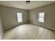 Bright bedroom with two large windows and wood-look vinyl flooring at 7606 E 46Th St, Indianapolis, IN 46226