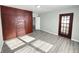 Bright bedroom with built-in wood closet and grey vinyl flooring at 810 W 2Nd St, Anderson, IN 46016