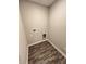 Simple laundry room with dark wood-look flooring at 9592 Beckett St, Avon, IN 46123