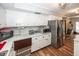 Kitchen with white cabinets, stainless steel appliances, and breakfast bar at 965 W New Rd, Greenfield, IN 46140