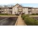 Inviting condo exterior with a blue door, walkway, and landscaping at 9820 Legends Creek Dr # 208, Indianapolis, IN 46229