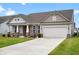 Tan and brick home with a large front yard and attached garage at 9860 Zion, Pendleton, IN 46064