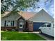 Brick and vinyl ranch home with a 2-car garage and landscaped lawn at 11720 Grenadier Ln, Indianapolis, IN 46229