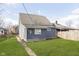 Gray house with a fenced backyard and grassy lawn at 209 Trowbridge St, Indianapolis, IN 46201