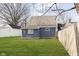 Large backyard with a grassy area and wooden fence at 209 Trowbridge St, Indianapolis, IN 46201